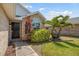 A welcoming entrance to a single Gathering home surrounded by lush landscaping and a brick exterior at 914 Smokerise Blvd, Port Orange, FL 32127