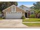 Charming single-Gathering home with brick facade, attached two-car garage and well-manicured lawn at 914 Smokerise Blvd, Port Orange, FL 32127