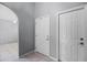 A neutral hallway featuring tile floors and multiple doorways showcasing great space and natural light at 914 Smokerise Blvd, Port Orange, FL 32127