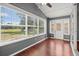 Inviting sunroom filled with natural light, wood flooring, and backyard views at 914 Smokerise Blvd, Port Orange, FL 32127