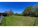 Lush backyard with mature trees and views of a tranquil body of water at 950 Windway Cir, Kissimmee, FL 34744