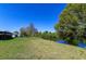 Expansive backyard with lush greenery, leading to a tranquil waterfront view, perfect for relaxation at 950 Windway Cir, Kissimmee, FL 34744