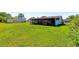 Expansive green backyard with a covered porch, perfect for outdoor living and entertaining at 950 Windway Cir, Kissimmee, FL 34744