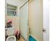Functional bathroom with a shower stall, toilet, and small window for natural light at 950 Windway Cir, Kissimmee, FL 34744