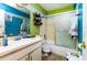 Well-lit bathroom with a shower-tub combo, a white vanity, and bright, colorful walls at 950 Windway Cir, Kissimmee, FL 34744