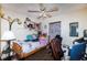 Cozy bedroom with a twin bed, ceiling fan, and ample shelf space for storage and display at 950 Windway Cir, Kissimmee, FL 34744