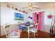 Charming dining room with hardwood floors, decorative wall art, and sheer curtains, ideal for intimate gatherings at 950 Windway Cir, Kissimmee, FL 34744