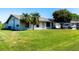 Charming single-story home with a spacious front yard and mature palm trees, perfect for curb appeal at 950 Windway Cir, Kissimmee, FL 34744