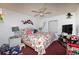 Relaxing main bedroom with a floral-themed bedspread, ceiling fan, and ample natural light for a serene retreat at 950 Windway Cir, Kissimmee, FL 34744