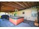 Covered patio featuring a hot tub, ceiling fans, and access to the backyard area at 950 Windway Cir, Kissimmee, FL 34744