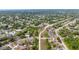 Residential neighborhood with tree-lined streets and well-maintained homes with a lake in the background at 999 Trumbull St, Deltona, FL 32725