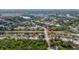Residential neighborhood with tree-lined streets and well-maintained homes with a lake in the background at 999 Trumbull St, Deltona, FL 32725