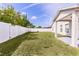 Spacious backyard features a well-maintained lawn, white fence, and covered patio, perfect for outdoor activities at 999 Trumbull St, Deltona, FL 32725