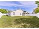 Spacious backyard features a well-maintained lawn, white fence, and covered patio, perfect for outdoor activities at 999 Trumbull St, Deltona, FL 32725