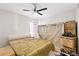 Bedroom featuring a bed, a ceiling fan, and moving boxes, showing the space and features at 999 Trumbull St, Deltona, FL 32725