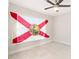 Bedroom with Florida flag in window, featuring tile floors, ceiling fan and bright lighting at 999 Trumbull St, Deltona, FL 32725