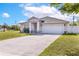 Charming single-story home with a well-maintained lawn and a two-car garage on a sunny day at 999 Trumbull St, Deltona, FL 32725
