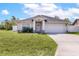 Charming home featuring a well-manicured lawn, two car garage, and neutral color palette at 999 Trumbull St, Deltona, FL 32725