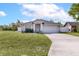 Charming home featuring a well-manicured lawn, two car garage, and neutral color palette at 999 Trumbull St, Deltona, FL 32725