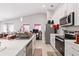 Modern kitchen with white cabinets, stainless steel appliances, and a view into the open floor plan at 999 Trumbull St, Deltona, FL 32725