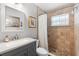 Bathroom featuring a shower, shower head, vanity and decorative mirror at 1560 S Pearl St, Deland, FL 32720