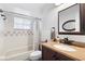 Bathroom featuring vanity, sink, toilet, shower and decorative mirror at 1560 S Pearl St, Deland, FL 32720