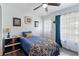 Comfortable bedroom featuring a ceiling fan, and natural light filtering in from the window and door at 1560 S Pearl St, Deland, FL 32720