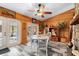 Bright dining area with wood paneling, natural light, and exterior access at 1560 S Pearl St, Deland, FL 32720