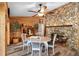 Dining area with stone fireplace, adjacent to wood paneled wall at 1560 S Pearl St, Deland, FL 32720