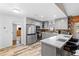 Bright kitchen featuring stainless steel appliances, gray cabinets, and a breakfast bar at 1560 S Pearl St, Deland, FL 32720
