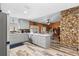 Open kitchen with gray cabinets, stone accents, and a breakfast bar island at 1560 S Pearl St, Deland, FL 32720