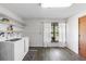 Clean laundry room with washer, dryer, shelving, and a bright window at 1560 S Pearl St, Deland, FL 32720