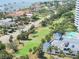 Beautiful aerial view of property with a golf course, pool, and waterfront access at 1 Oceans West Blvd # 20B4, Daytona Beach, FL 32118