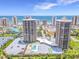 Beautiful aerial view of waterfront condos, pool, landscaping, and beachfront views at 1 Oceans West Blvd # 20B4, Daytona Beach, FL 32118