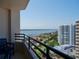 Stunning balcony view overlooking lush greenery, waterfront, and a neighboring high-rise building at 1 Oceans West Blvd # 20B4, Daytona Beach, FL 32118
