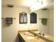 Bright bathroom featuring granite countertops, vanity, and a mirrored medicine cabinet at 1 Oceans West Blvd # 20B4, Daytona Beach, FL 32118