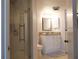Bright bathroom featuring a glass shower and vanity with granite countertops at 1 Oceans West Blvd # 20B4, Daytona Beach, FL 32118