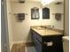 Charming bathroom featuring granite countertop, dark wood cabinets, and modern fixtures at 1 Oceans West Blvd # 20B4, Daytona Beach, FL 32118