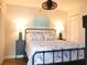 Comfortable bedroom with patterned bedding, lamps, and ceiling fan at 1 Oceans West Blvd # 20B4, Daytona Beach, FL 32118