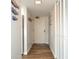 Bright hallway with wood-look flooring and coastal-themed decor leading to the main living areas at 1 Oceans West Blvd # 20B4, Daytona Beach, FL 32118