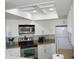 Bright kitchen featuring white cabinetry, stainless steel appliances, and modern granite countertops at 1 Oceans West Blvd # 20B4, Daytona Beach, FL 32118