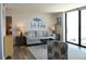 Cozy living room features water views from the large window and coastal decor at 1 Oceans West Blvd # 20B4, Daytona Beach, FL 32118