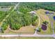 Aerial view of a large property with sprawling lawns, a pond, and a home surrounded by trees at 1015 Tallacoe Trl, New Smyrna Beach, FL 32168