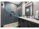 Modern bathroom featuring sleek tiles, a glass-enclosed shower, and a stylish vanity at 1015 Tallacoe Trl, New Smyrna Beach, FL 32168