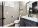 Charming powder room featuring a modern vanity, decorative artwork, and stylish fixtures at 1015 Tallacoe Trl, New Smyrna Beach, FL 32168