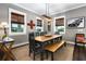 Elegant dining room with a long table, bench seating, stylish lighting, and tasteful decor at 1015 Tallacoe Trl, New Smyrna Beach, FL 32168