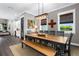Inviting dining room featuring a large wooden table, modern lighting, and neutral decor at 1015 Tallacoe Trl, New Smyrna Beach, FL 32168