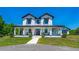 Charming two-story modern farmhouse with inviting front porch and well-maintained landscaping at 1015 Tallacoe Trl, New Smyrna Beach, FL 32168