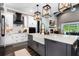 Bright kitchen with a farmhouse sink in a gray island, white cabinetry, pendant lights, and stainless steel appliances at 1015 Tallacoe Trl, New Smyrna Beach, FL 32168