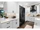 Modern kitchen showcasing white cabinetry, subway tile backsplash, stainless steel appliances, and sleek black hardware at 1015 Tallacoe Trl, New Smyrna Beach, FL 32168